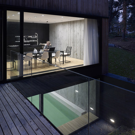Timber-clad seaside house with a grainy concrete interior by Ultra Architects
