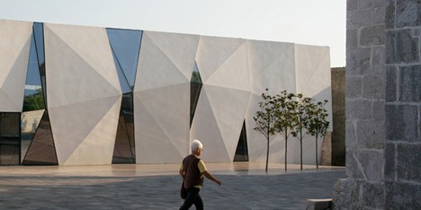 Concrete-clad sports hall by Idis Turato with both faceted and bumpy facades