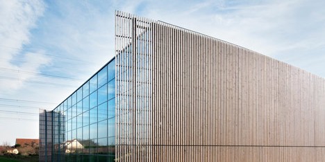 Sports centre clad with sun-bleached wooden slats by Explorations Architecture