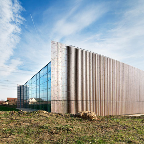Sports centre clad with sun-bleached wooden slats by Explorations Architecture