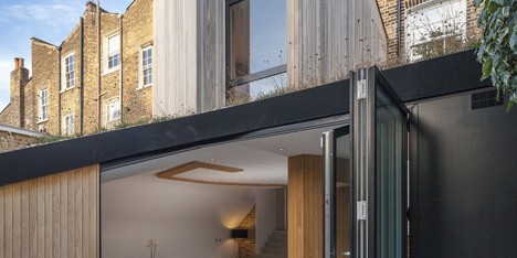 Curvy timber extension by Scott Architects features a sloping grass roof