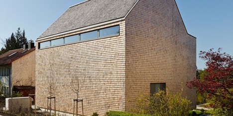 Stuttgart house by (se)arch with shingle-clad walls and a triple-height art gallery