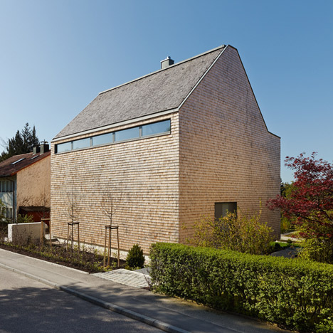 Stuttgart house by (se)arch with shingle-clad walls and a triple-height art gallery