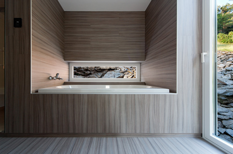 Woodland retreat by Béres Architects nestles up against a jagged rock face