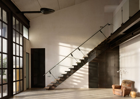 Pivoting steel doors lead into Studio Sitges, a house and photography studio in Spain by Olson Kundig