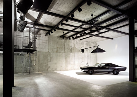 Pivoting steel doors lead into Studio Sitges, a house and photography studio in Spain by Olson Kundig