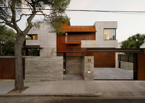 Pivoting steel doors lead into Studio Sitges, a house and photography studio in Spain by Olson Kundig