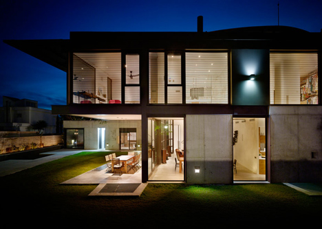 Pivoting steel doors lead into Studio Sitges, a house and photography studio in Spain by Olson Kundig