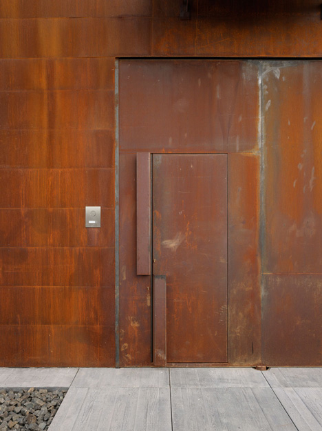 Pivoting steel doors lead into Studio Sitges, a house and photography studio in Spain by Olson Kundig