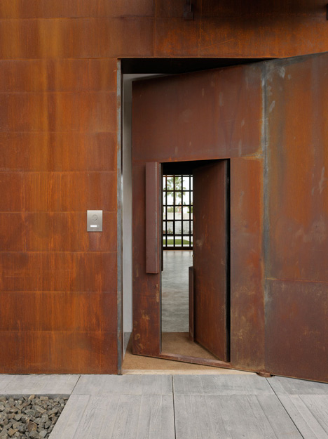 Pivoting steel doors lead into Studio Sitges, a house and photography studio in Spain by Olson Kundig
