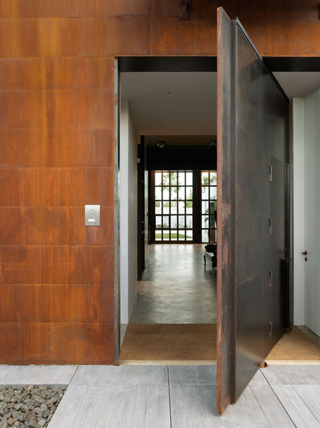 Pivoting steel doors lead into Studio Sitges, a house and photography studio in Spain by Olson Kundig