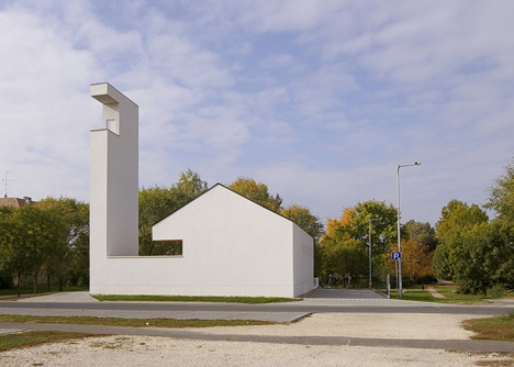 Church congregation hall by SAGRA Architects features a towering white bell tower