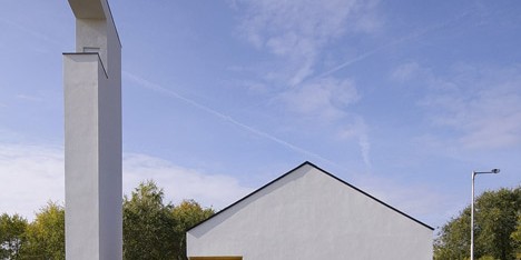 Church congregation hall by SAGRA Architects features a towering white bell tower