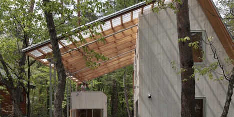 Cedar-clad villa by Naka Studio shelters a huge terrace beneath its roof
