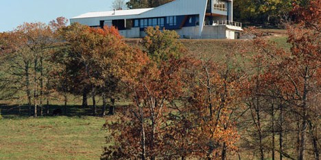 Angular metal roof wraps around a hilltop house by deMx architecture