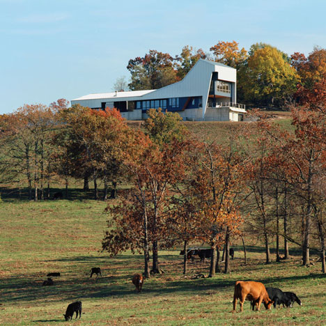 Angular metal roof wraps around a hilltop house by deMx architecture