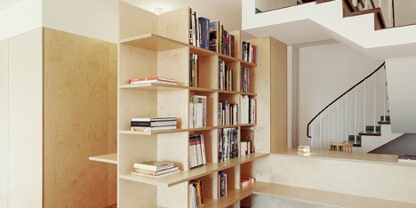Wooden structures combine partitions and furniture inside home by João Branco
