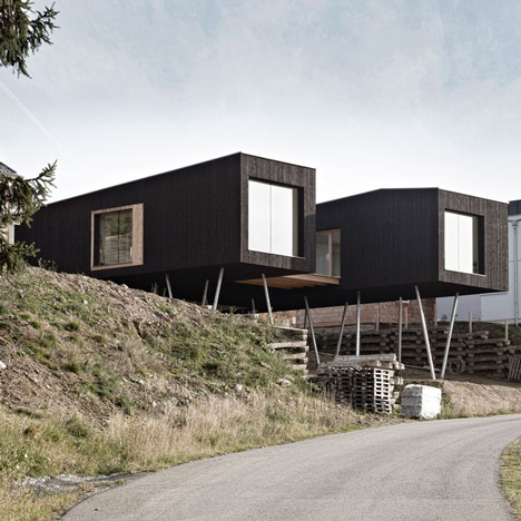 Black-painted S House by Hammerschmid Pachl Seebacher raised up on stilts