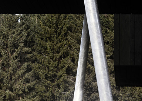 Black-painted S House by Hammerschmid Pachl Seebacher raised up on stilts