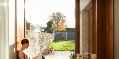 House extension by GKMP Architects includes a wooden window seat