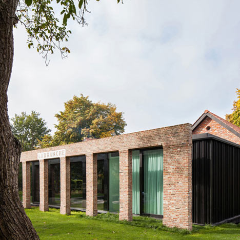 Brick colonnade screens renovated hunting lodge by DMOA Architecten