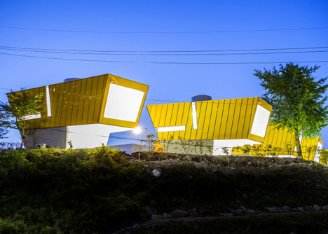 Asymmetric holiday homes by Studio Koossino feature bright yellow walls