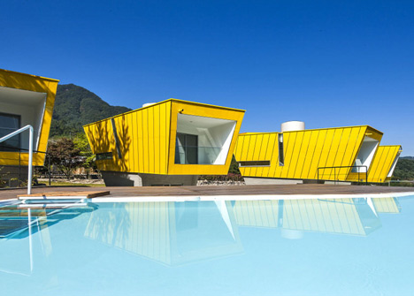 Asymmetric holiday homes by Studio Koossino feature bright yellow walls