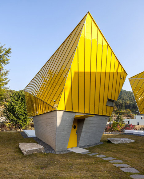Asymmetric holiday homes by Studio Koossino feature bright yellow walls