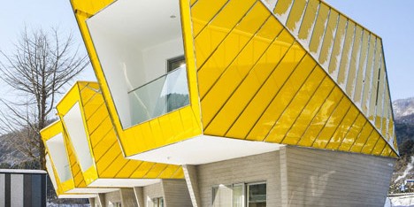 Asymmetric holiday homes by Studio Koossino feature bright yellow walls