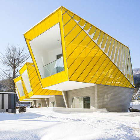 Asymmetric holiday homes by Studio Koossino feature bright yellow walls