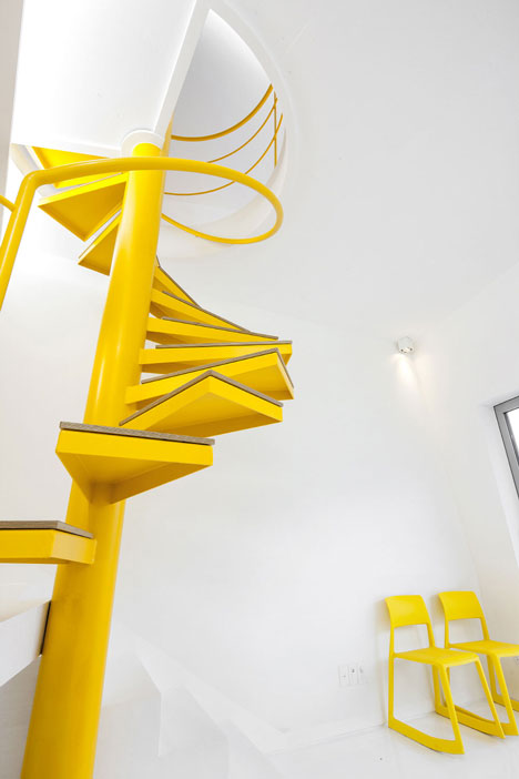 Asymmetric holiday homes by Studio Koossino feature bright yellow walls