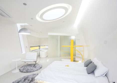 Asymmetric holiday homes by Studio Koossino feature bright yellow walls