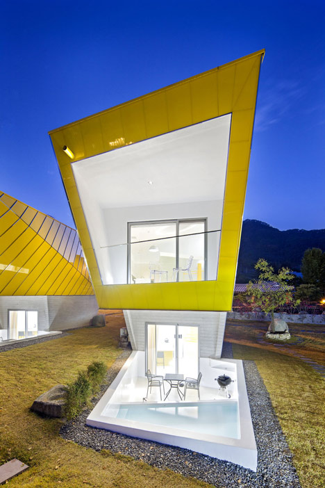 Asymmetric holiday homes by Studio Koossino feature bright yellow walls