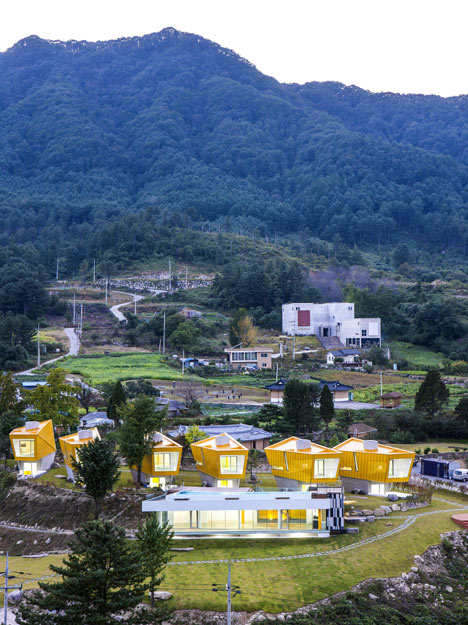 Asymmetric holiday homes by Studio Koossino feature bright yellow walls