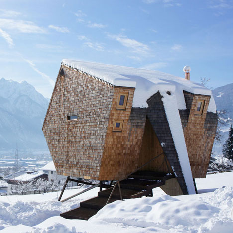Alpine holiday cabin by Peter Jungmann has metal feet and a beak