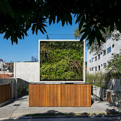 Wall of bushy plants fronts Sao Paulo housing block by TACOA