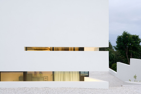 Doorway hidden in volcanic stone wall of B25 house by PK Arkitektar