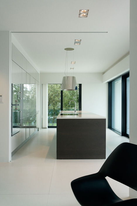 Doorway hidden in volcanic stone wall of B25 house by PK Arkitektar