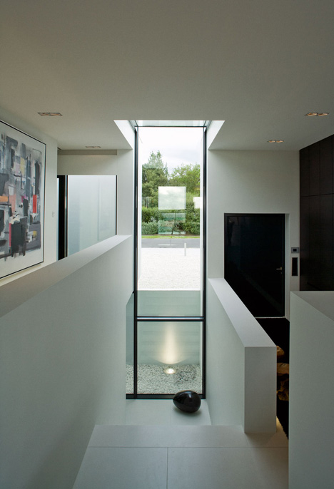 Doorway hidden in volcanic stone wall of B25 house by PK Arkitektar