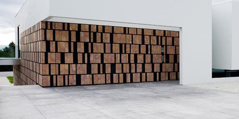 Doorway hidden in volcanic stone wall of B25 house by PK Arkitektar