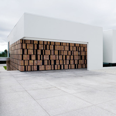 Doorway hidden in volcanic stone wall of B25 house by PK Arkitektar