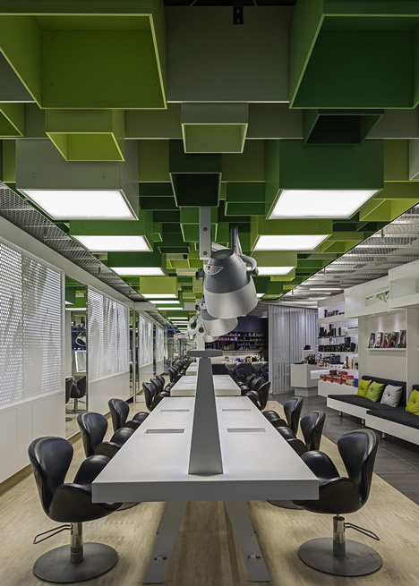Green boxes cover the ceiling of Clip Drop In hair salon by Sweco Architects