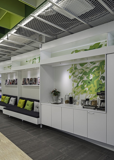 Green boxes cover the ceiling of Clip Drop In hair salon by Sweco Architects