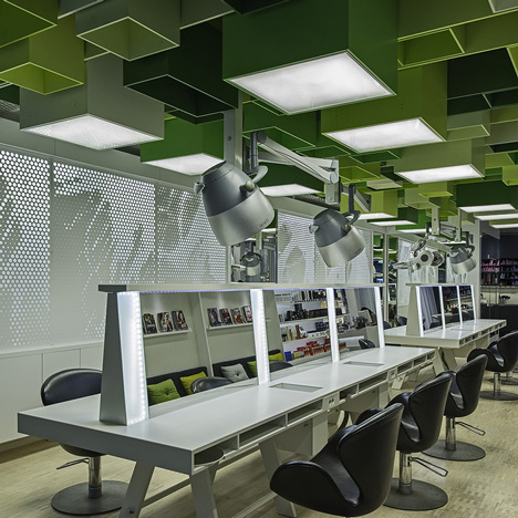 Green boxes cover the ceiling of Clip Drop In hair salon by Sweco Architects