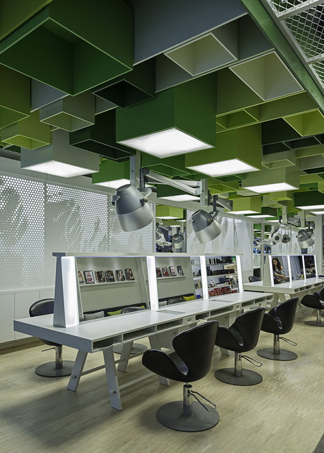 Green boxes cover the ceiling of Clip Drop In hair salon by Sweco Architects