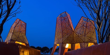 Four-legged perforated metal pavilions rise above Fengming Mountain Park