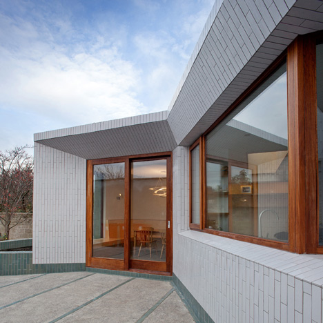 Tile-covered walls reflect light into Greenlea Road extension by GKMP Architects