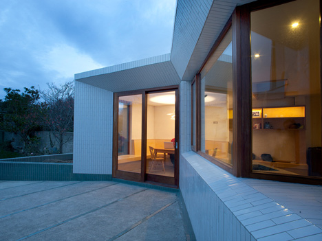 Tile-covered walls reflect light into Greenlea Road extension by GKMP Architects