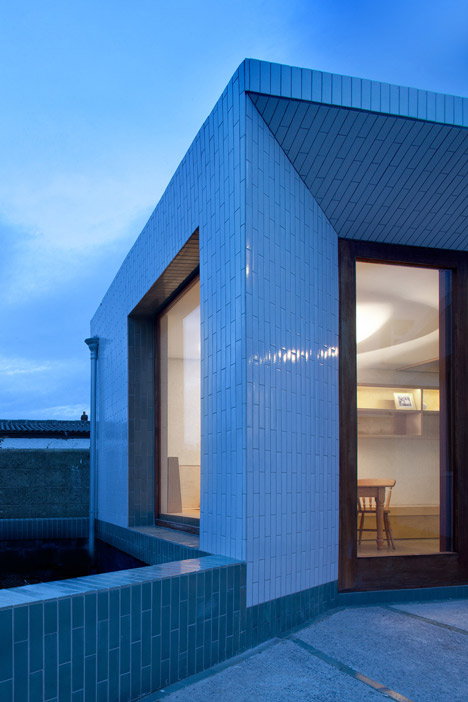 Tile-covered walls reflect light into Greenlea Road extension by GKMP Architects