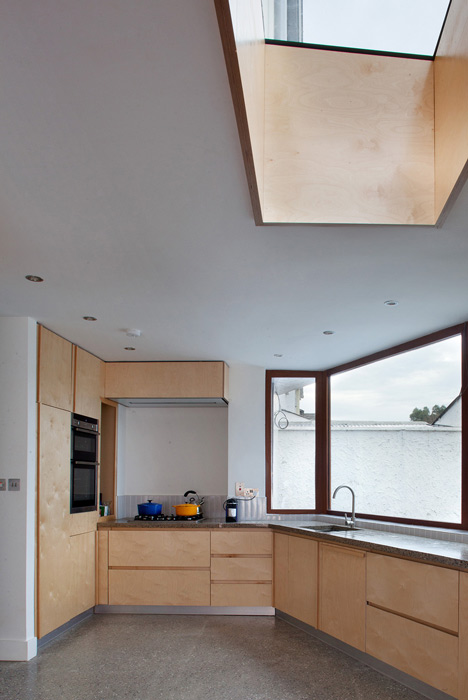 Tile-covered walls reflect light into Greenlea Road extension by GKMP Architects